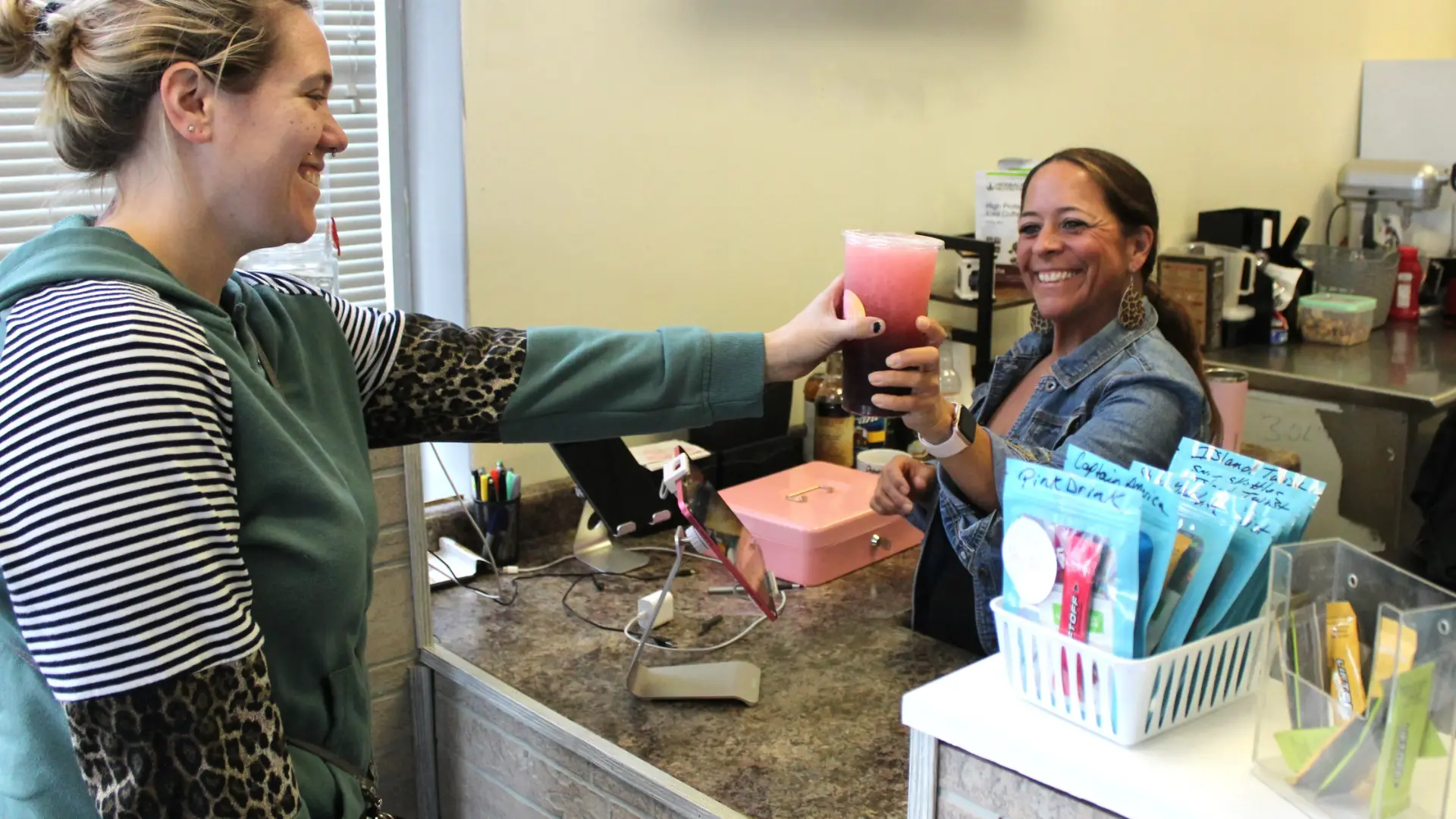 Kim handing a customer a fresh tea